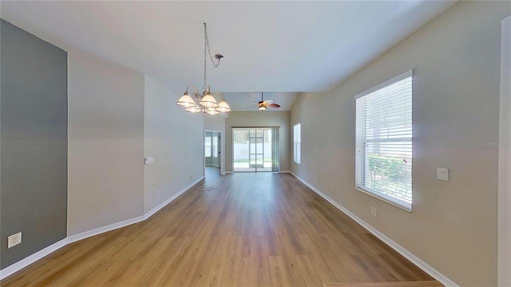 10620 Whittington Court Largo, FL 33771 - Photo 29 of 68 a view of a room with wooden floor and chandelier