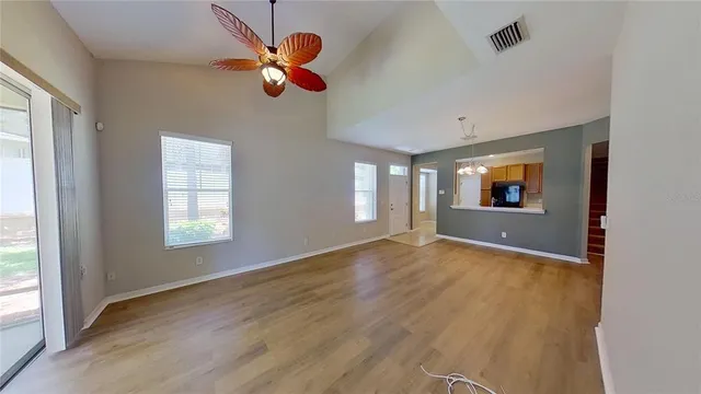 a view of a livingroom with a ceiling fan and window