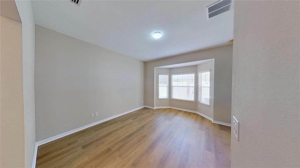 10620 Whittington Court Largo, FL 33771 - Photo 36 of 68 a view of empty room with wooden floor and fan