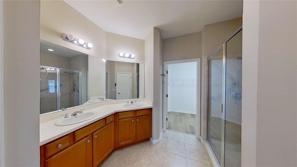 10620 Whittington Court Largo, FL 33771 - Photo 37 of 68 a bathroom with a double vanity sink mirror and double