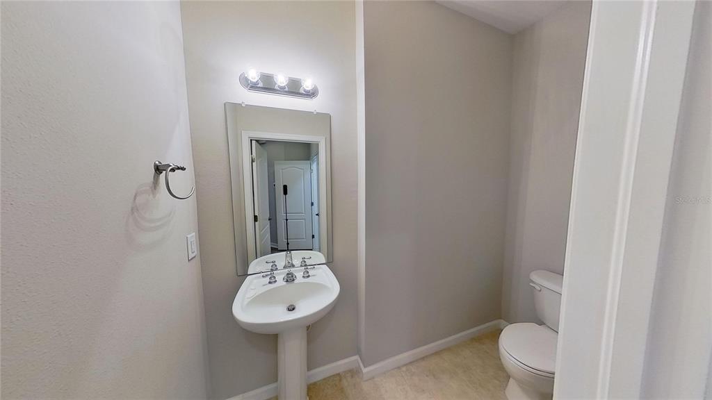 10620 Whittington Court Largo, FL 33771 - Photo 45 of 68 a bathroom with a sink a toilet and mirror