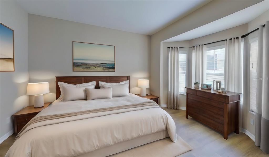 10620 Whittington Court Largo, FL 33771 - Photo 5 of 68 a bedroom with a bed and a night stand