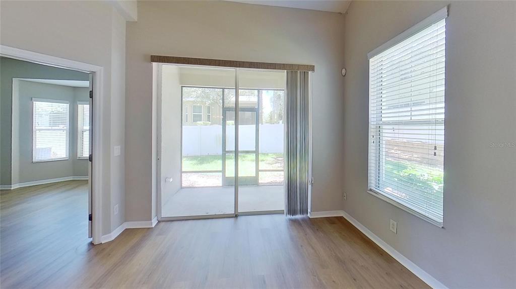 10620 Whittington Court Largo, FL 33771 - Photo 54 of 68 a view of an empty room with wooden floor and a window