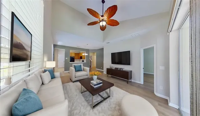 a living room with furniture flat screen tv and large window