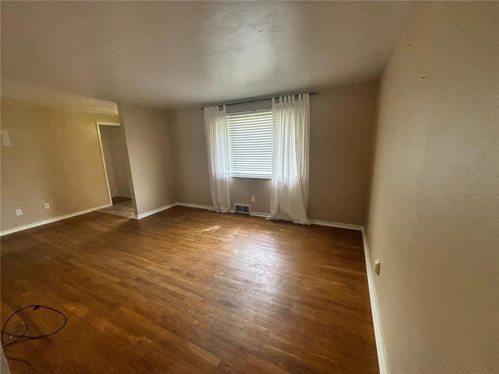 270 Wheeler Avenue McKees Rocks, PA 15136 - Photo 8 of 28 an empty room with wooden floor and windows