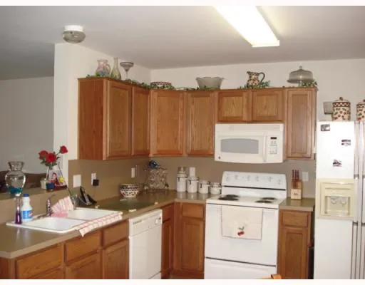 a kitchen with a sink cabinets and appliances