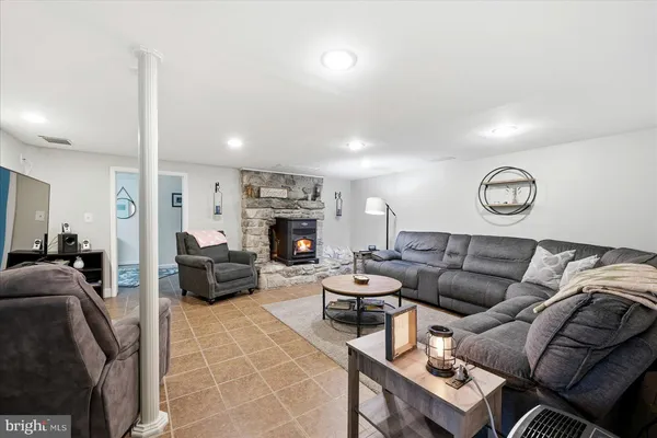 a living room with furniture a fireplace and a flat screen tv