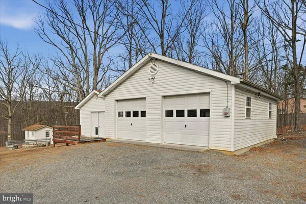 a view of a white house with a large space area and garage