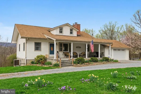 a front view of a house with a yard and porch