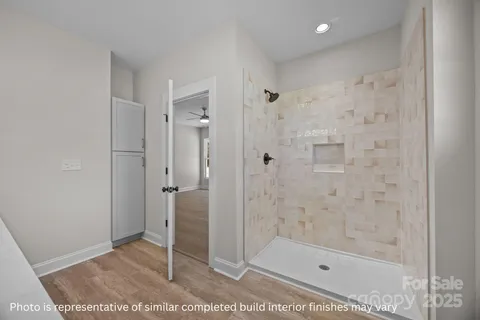 a bathroom with a shower and a sink