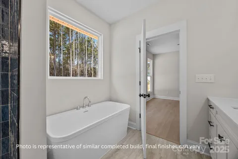 a white bath tub sitting next to a shower
