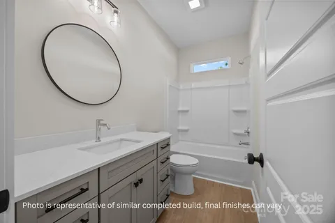 a bathroom with a sink a toilet and a mirror