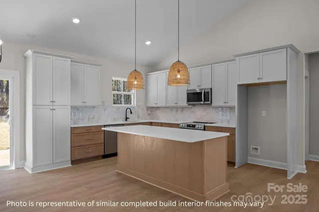 a kitchen with stainless steel appliances granite countertop a sink and a stove