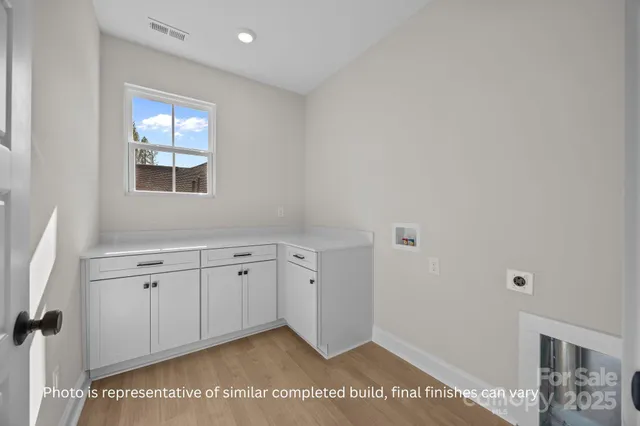 a view of a kitchen with granite countertop cabinets