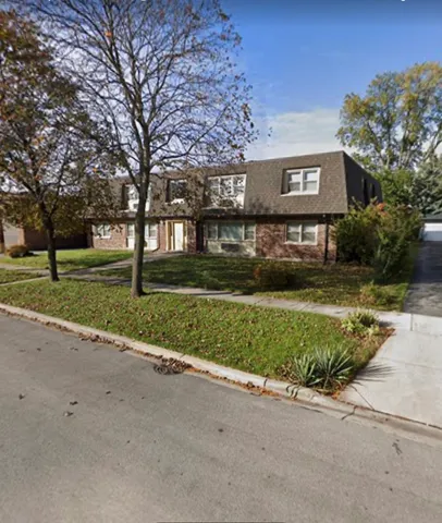 a front view of house with a garden