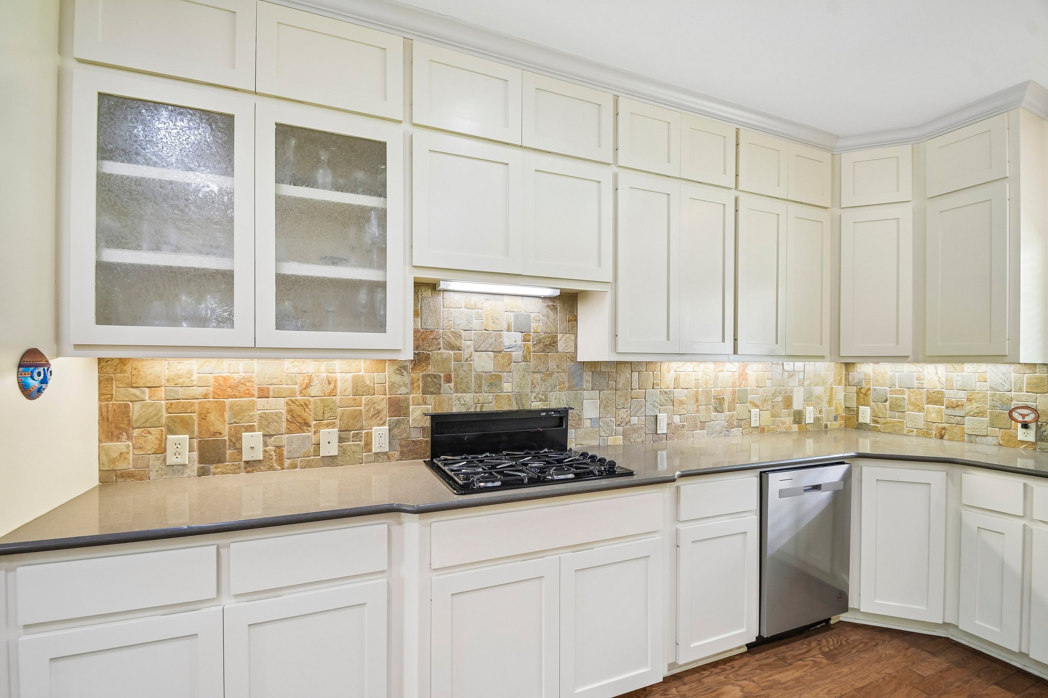 307 West 4th Street Elgin, TX 78621 - Photo 12 of 40 Kitchen featuring abundant white cabinetry, a stone tile backsplash, and a built-in stainless steel dishwasher