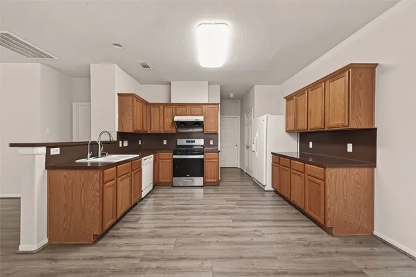 a kitchen with stainless steel appliances granite countertop a sink stove and microwave