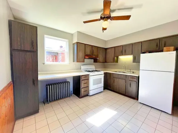 a kitchen with stainless steel appliances granite countertop a refrigerator sink and cabinets