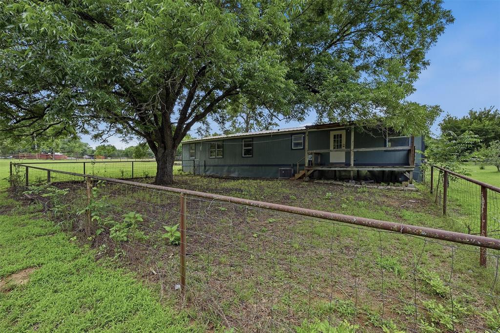 150 Gilbreath Road Sadler, TX 76264 - Photo 31 of 34 a backyard of a house with lots of green space