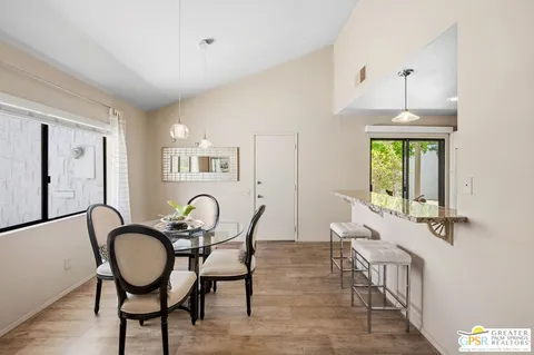 a kitchen with stainless steel appliances granite countertop a table and chairs