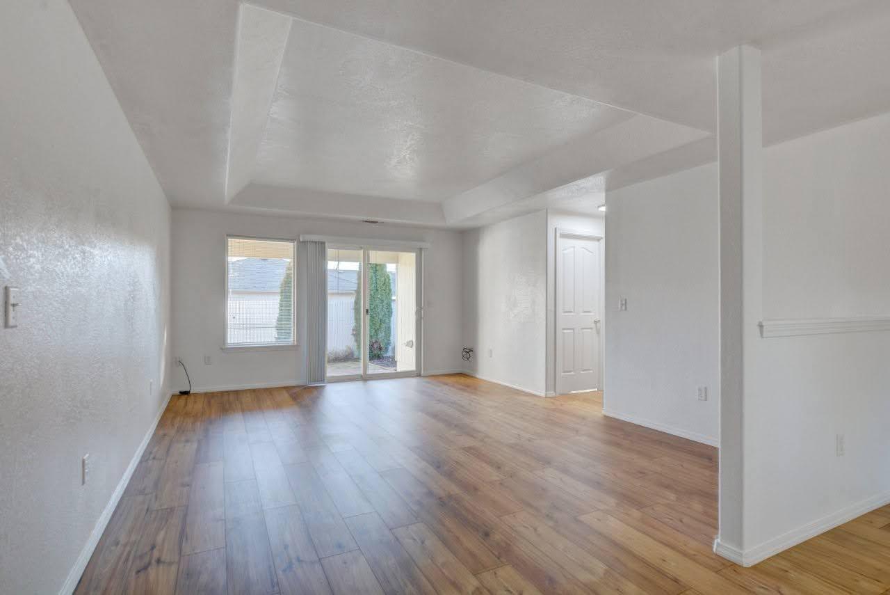 417 Crystal Drive Eagle Point, OR 97524 - Photo 6 of 35 a view of an empty room with wooden floor and window
