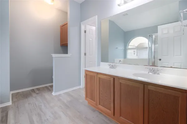 a bathroom with a double vanity sink and a mirror
