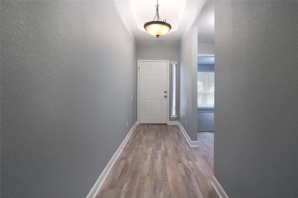 a view of a room with wooden floor