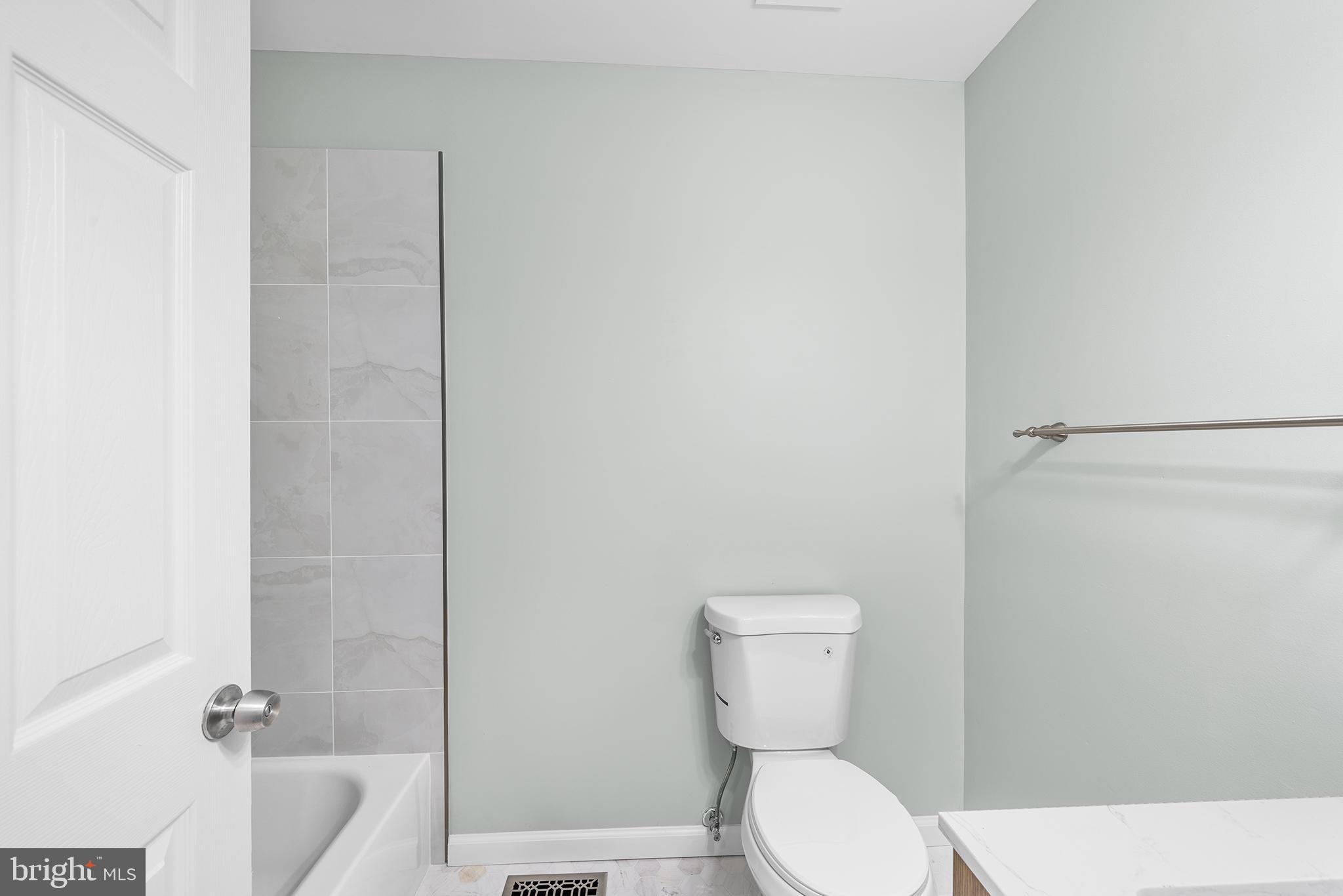 5202 Ridge Avenue Philadelphia, PA 19128 - Photo 13 of 30 a white toilet sitting next to a bath tub