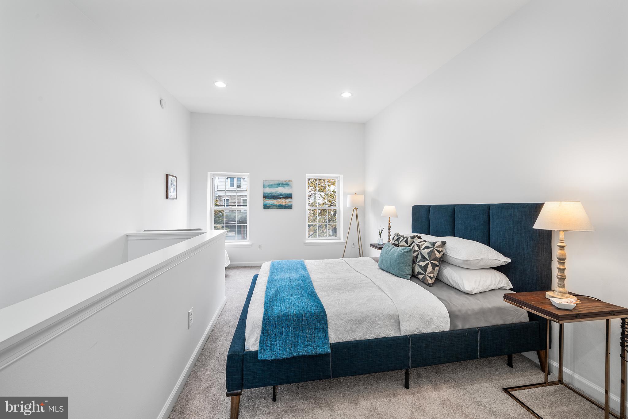 5202 Ridge Avenue Philadelphia, PA 19128 - Photo 20 of 30 a bedroom with a bed and a lamp with window