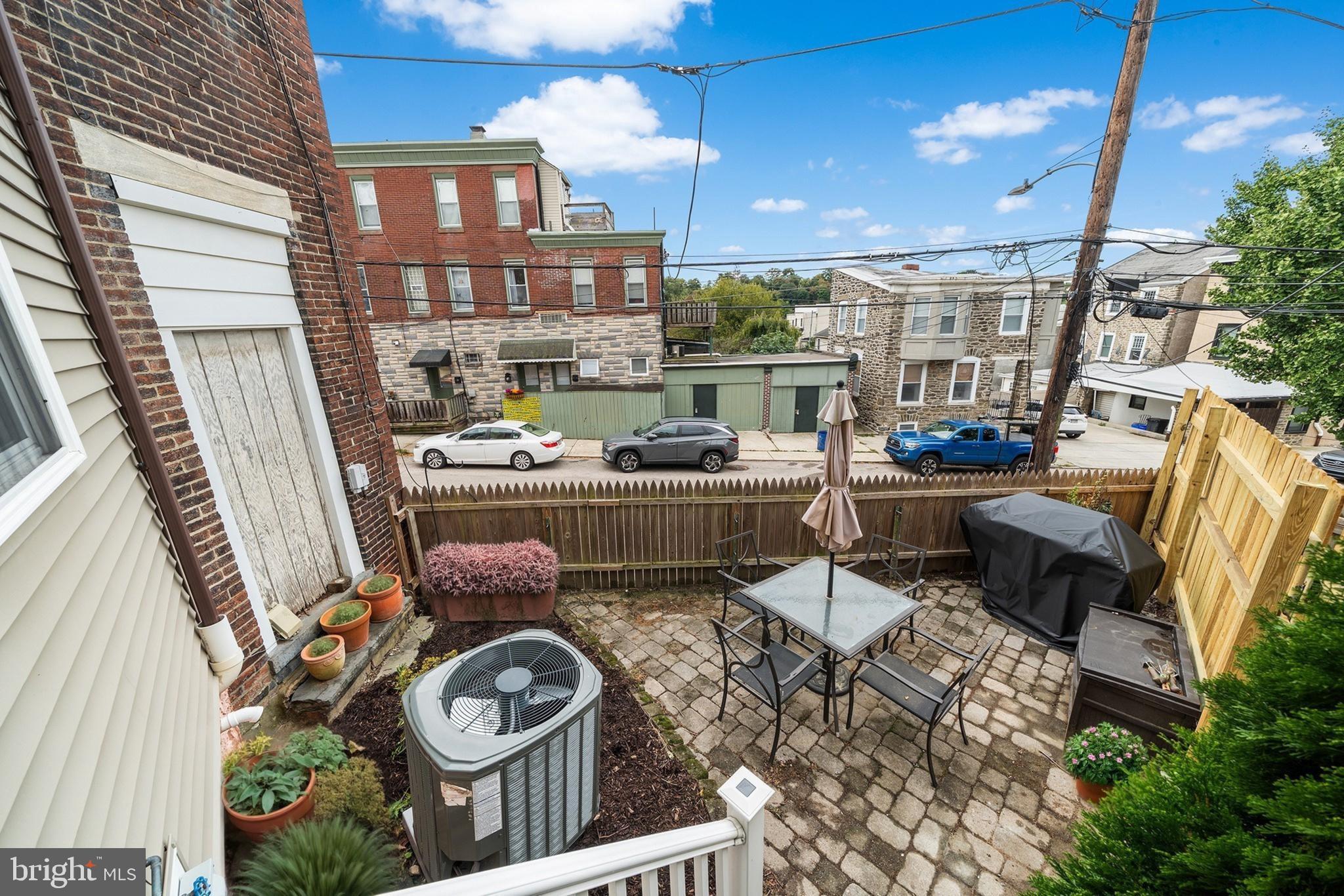 5202 Ridge Avenue Philadelphia, PA 19128 - Photo 27 of 30 a table and chairs in front of a building