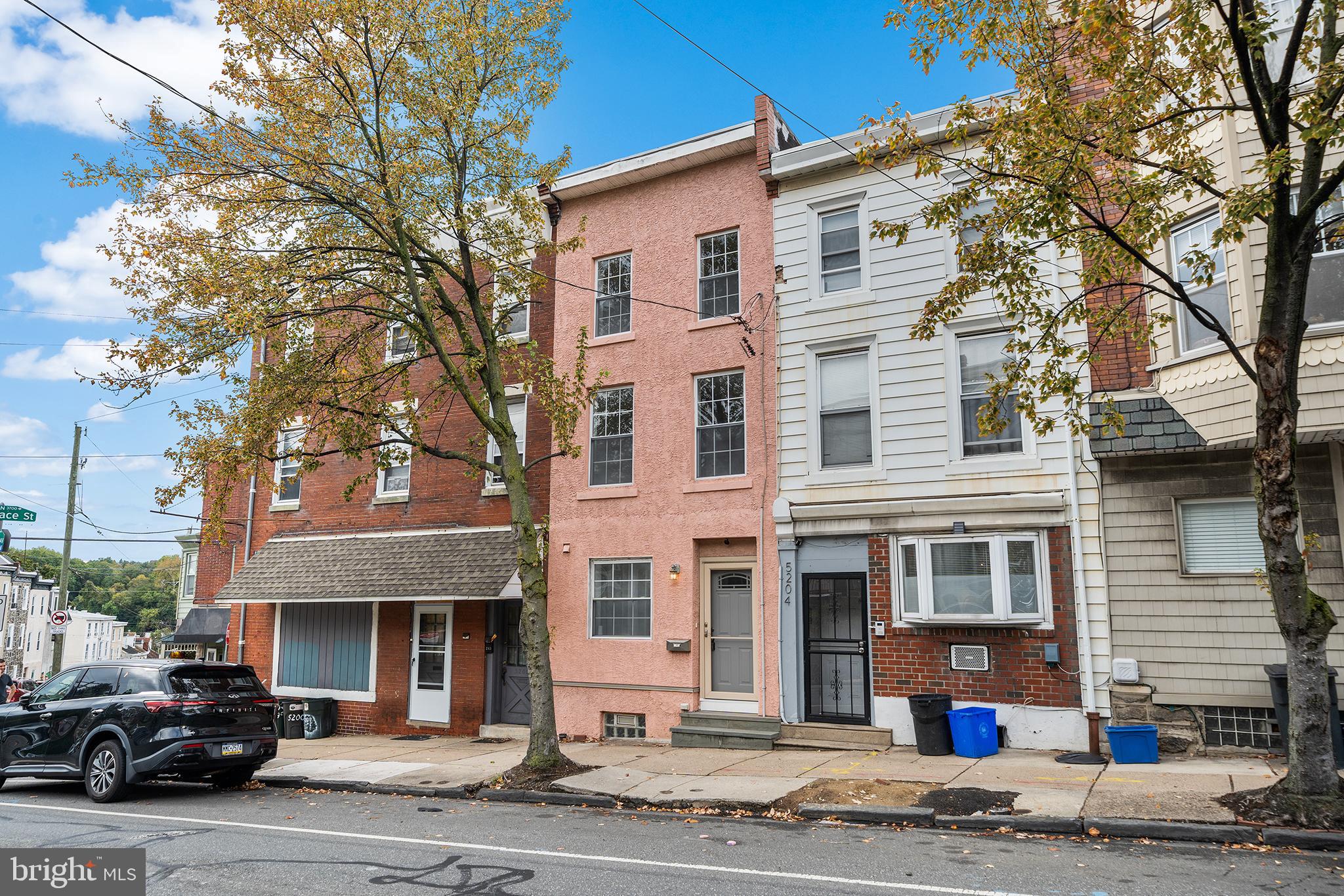 5202 Ridge Avenue Philadelphia, PA 19128 - Photo 29 of 30 a front view of a residential apartment building with a yard