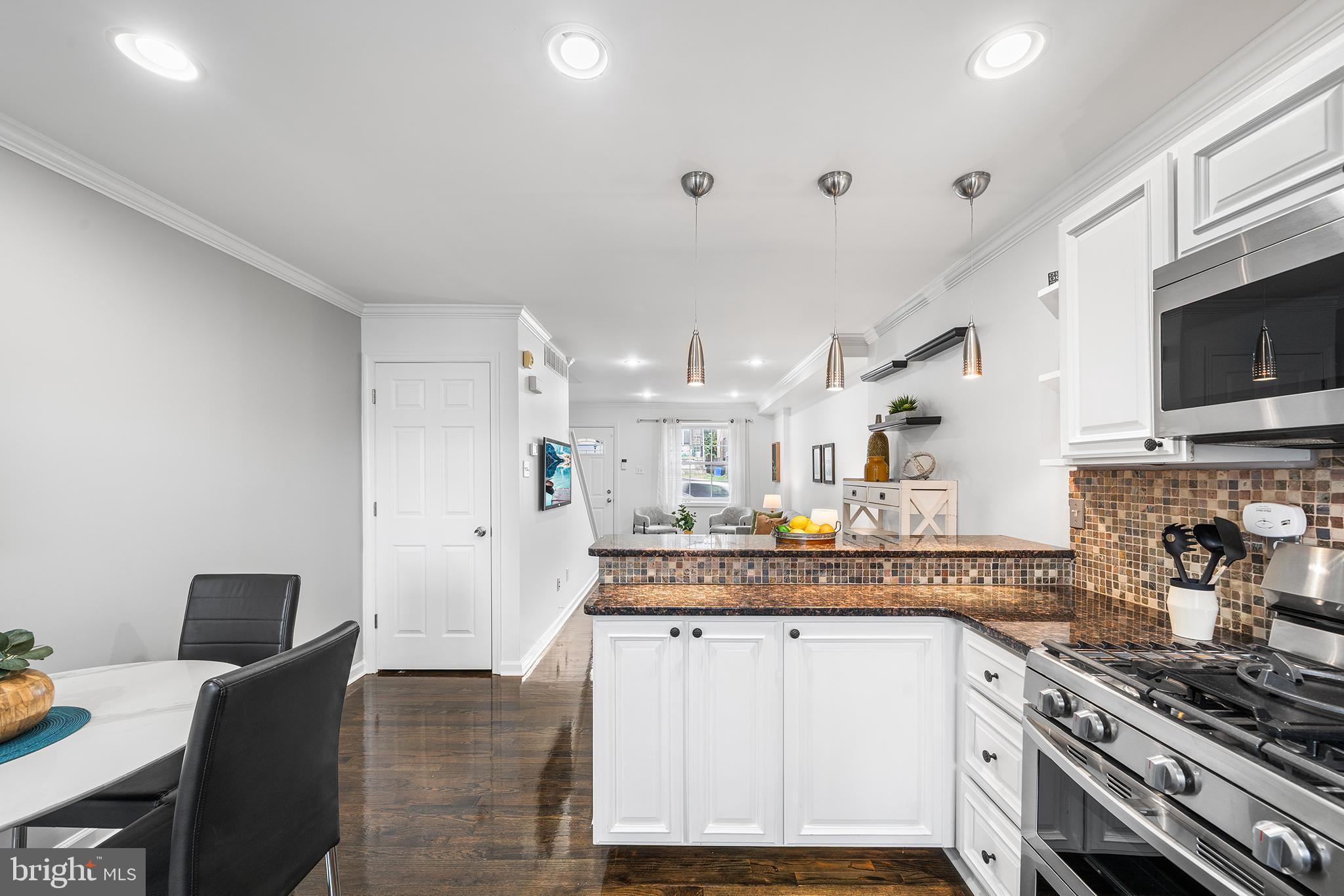 5202 Ridge Avenue Philadelphia, PA 19128 - Photo 7 of 30 a kitchen with stainless steel appliances granite countertop a stove and a sink