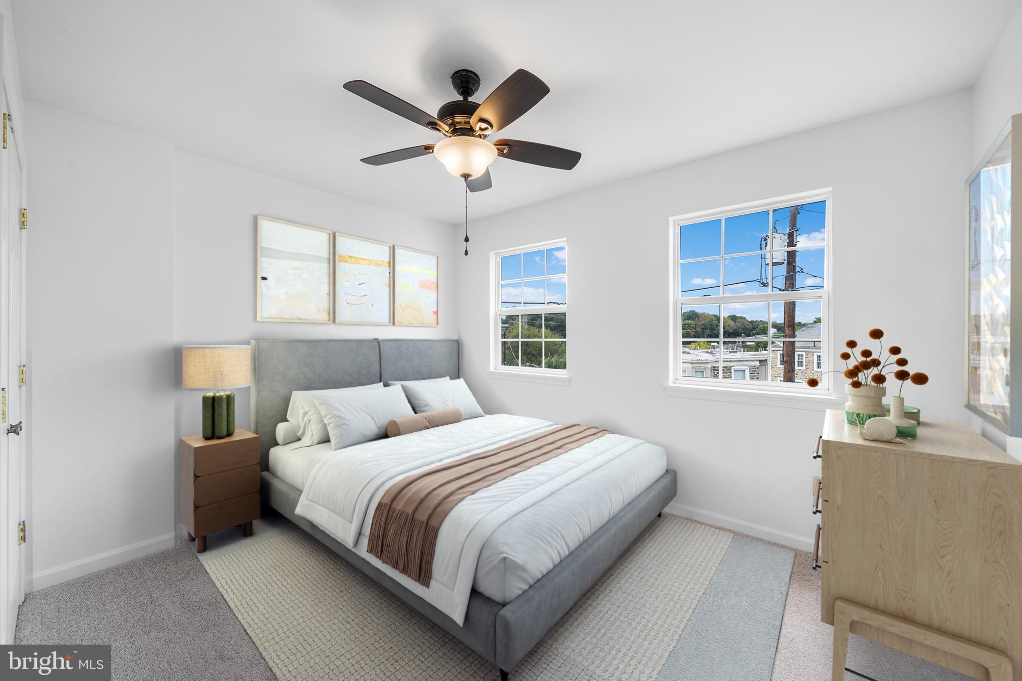 5202 Ridge Avenue Philadelphia, PA 19128 - Photo 9 of 30 a bedroom with a large bed and a chandelier