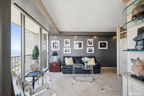 a living room with furniture and large windows
