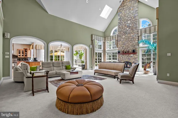 a living room with furniture large window and a fireplace
