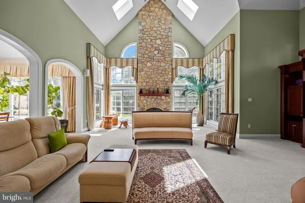a dining room with furniture a large window and wooden floor