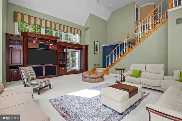 a dining room with furniture a chandelier and wooden floor