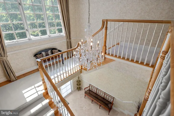 a bed sitting in a spacious bedroom next to a window