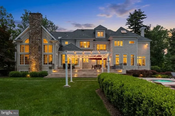a kitchen with stainless steel appliances kitchen island granite countertop a stove a sink a dining table and chairs
