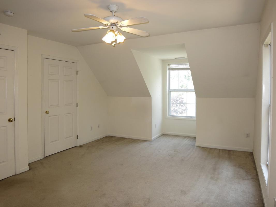 320 Davie Road Carrboro, NC 27510 - Photo 15 of 20 an empty room with windows and fan