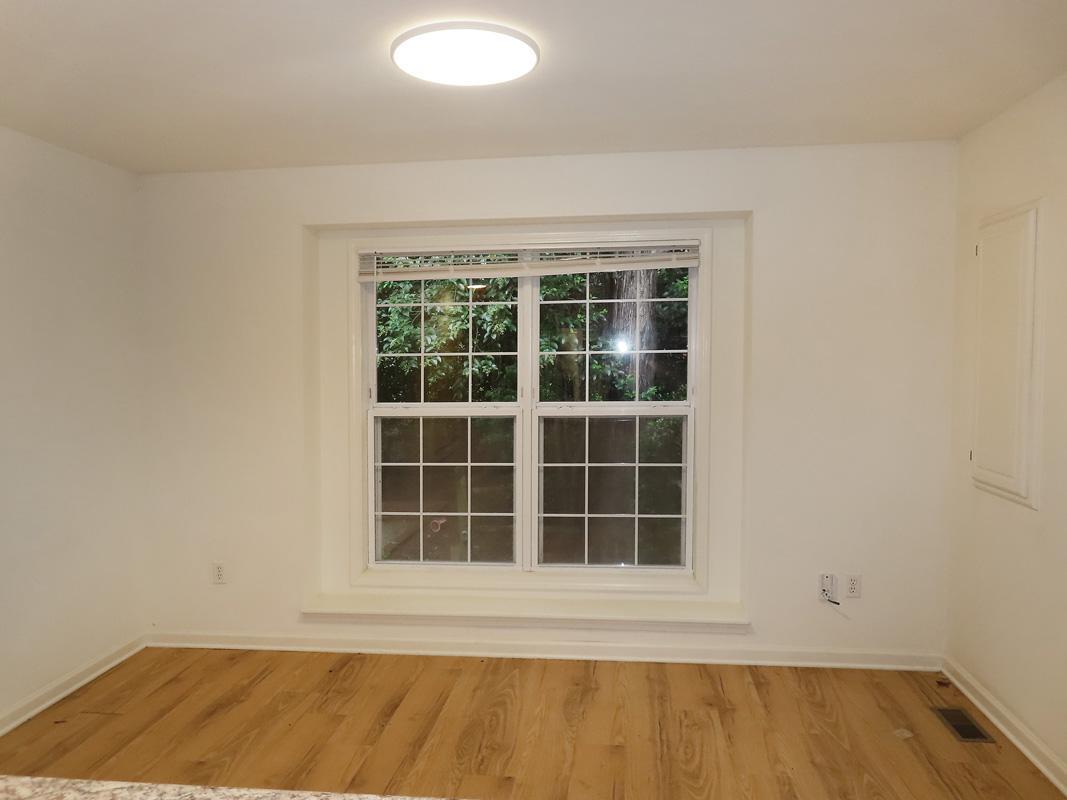 320 Davie Road Carrboro, NC 27510 - Photo 6 of 20 a view of empty room with wooden floor and windows