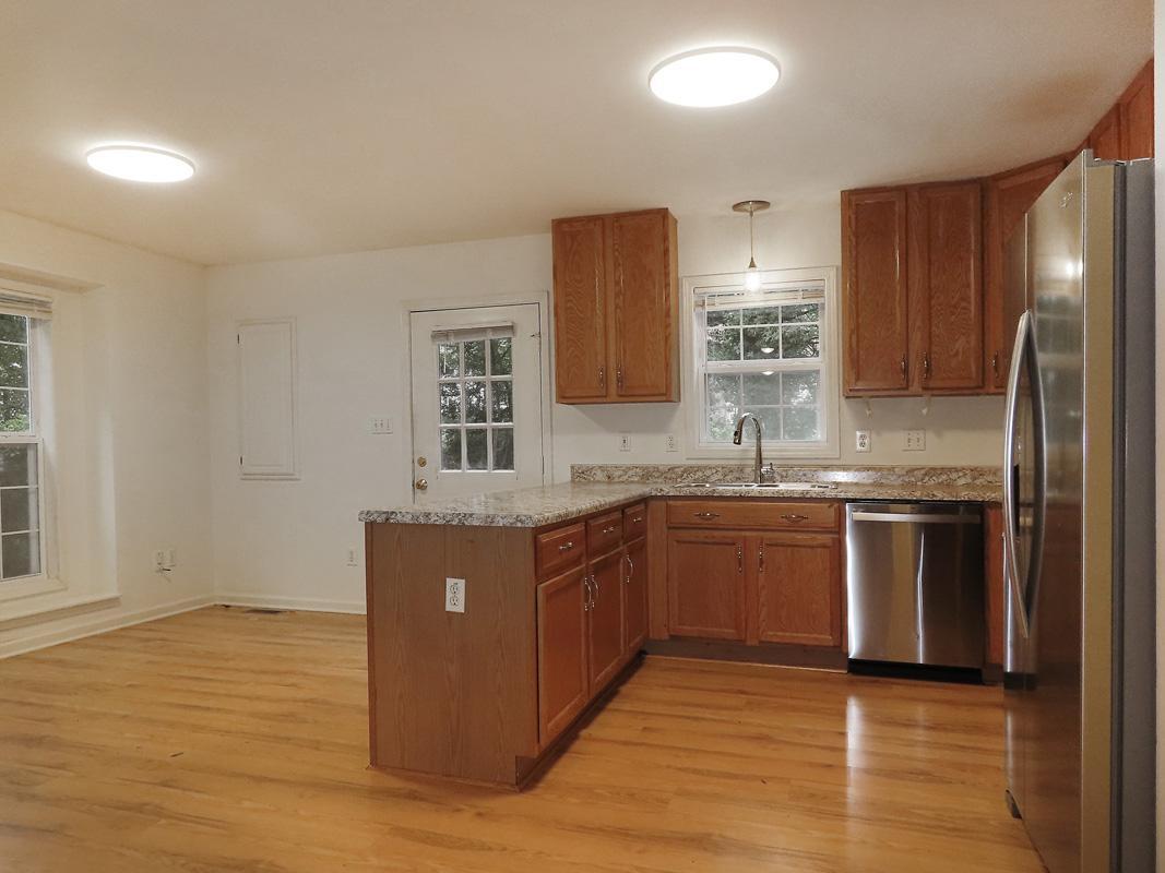 320 Davie Road Carrboro, NC 27510 - Photo 7 of 20 a kitchen with stainless steel appliances granite countertop a sink and stove top oven