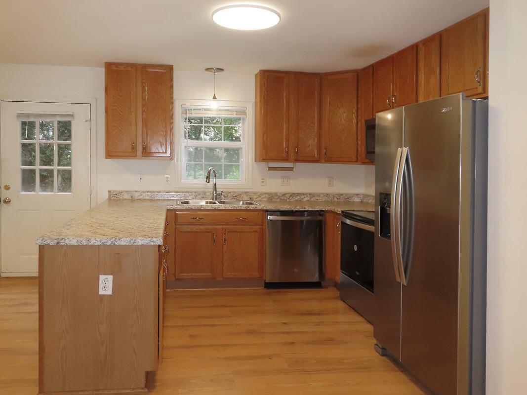 320 Davie Road Carrboro, NC 27510 - Photo 8 of 20 a kitchen with stainless steel appliances granite countertop a refrigerator a stove a sink and a microwave