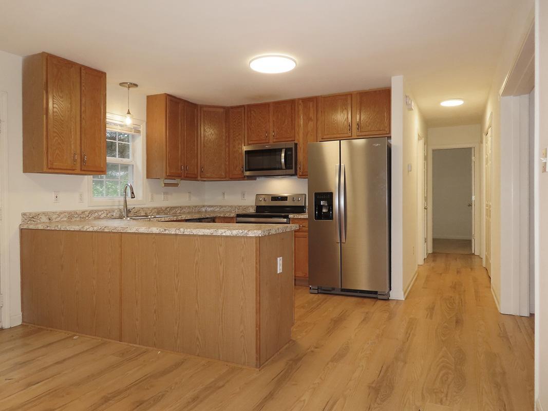 320 Davie Road Carrboro, NC 27510 - Photo 10 of 20 a kitchen with granite countertop a refrigerator and a sink