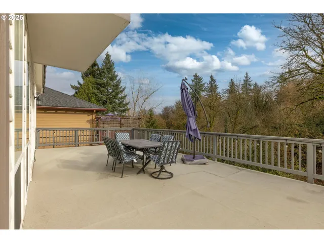 a view of a patio with a table and chairs