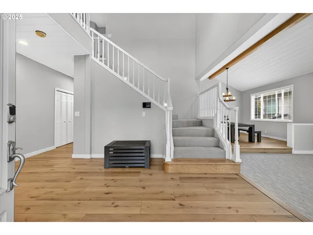 a view of entryway and hall with wooden floor