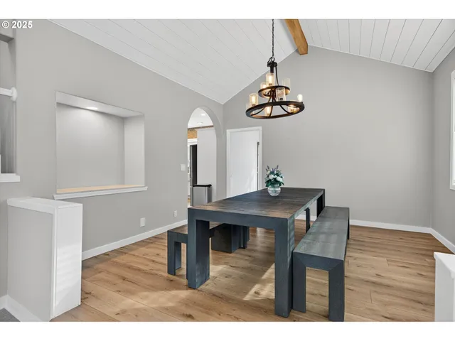 a living room with a table and chairs