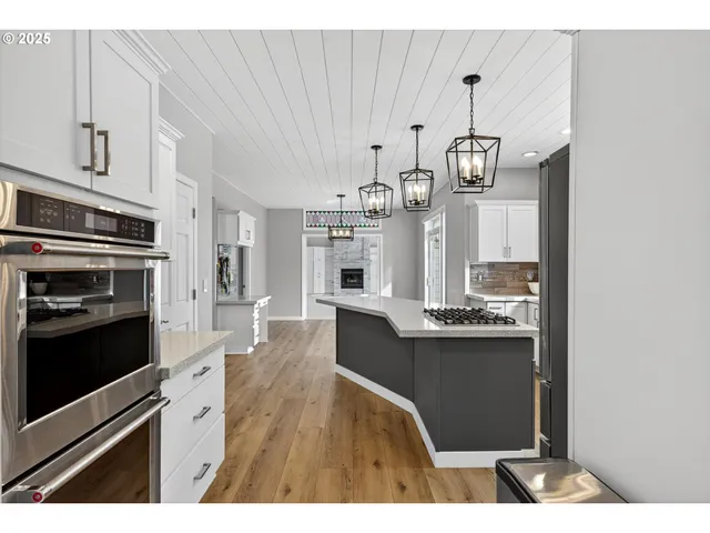 a kitchen with stainless steel appliances granite countertop a stove and cabinets