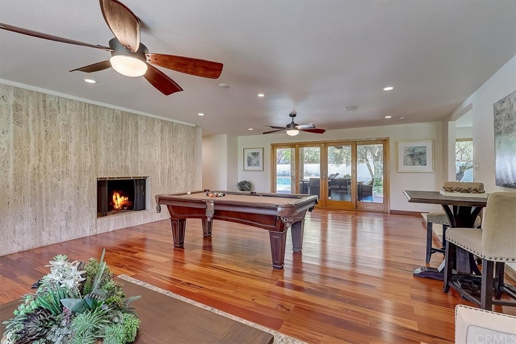 12392 Ranchview Drive Santa Ana, CA 92705 - Photo 24 of 72 a living room with furniture a fireplace and a floor to ceiling window