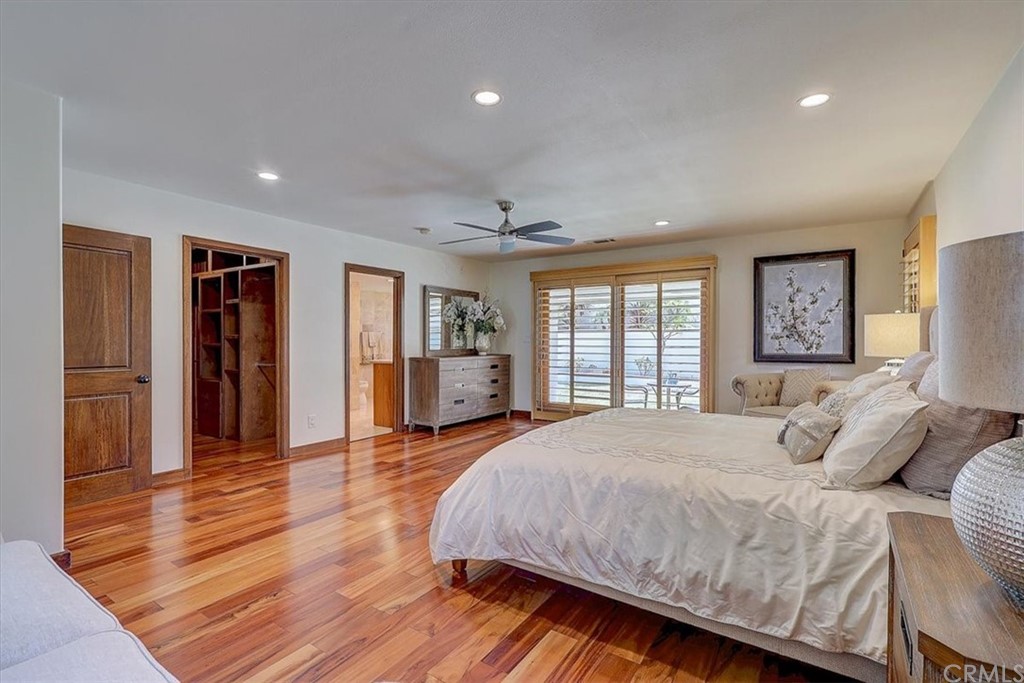 12392 Ranchview Drive Santa Ana, CA 92705 - Photo 35 of 72 a spacious bedroom with a bed and a dresser with wooden floor